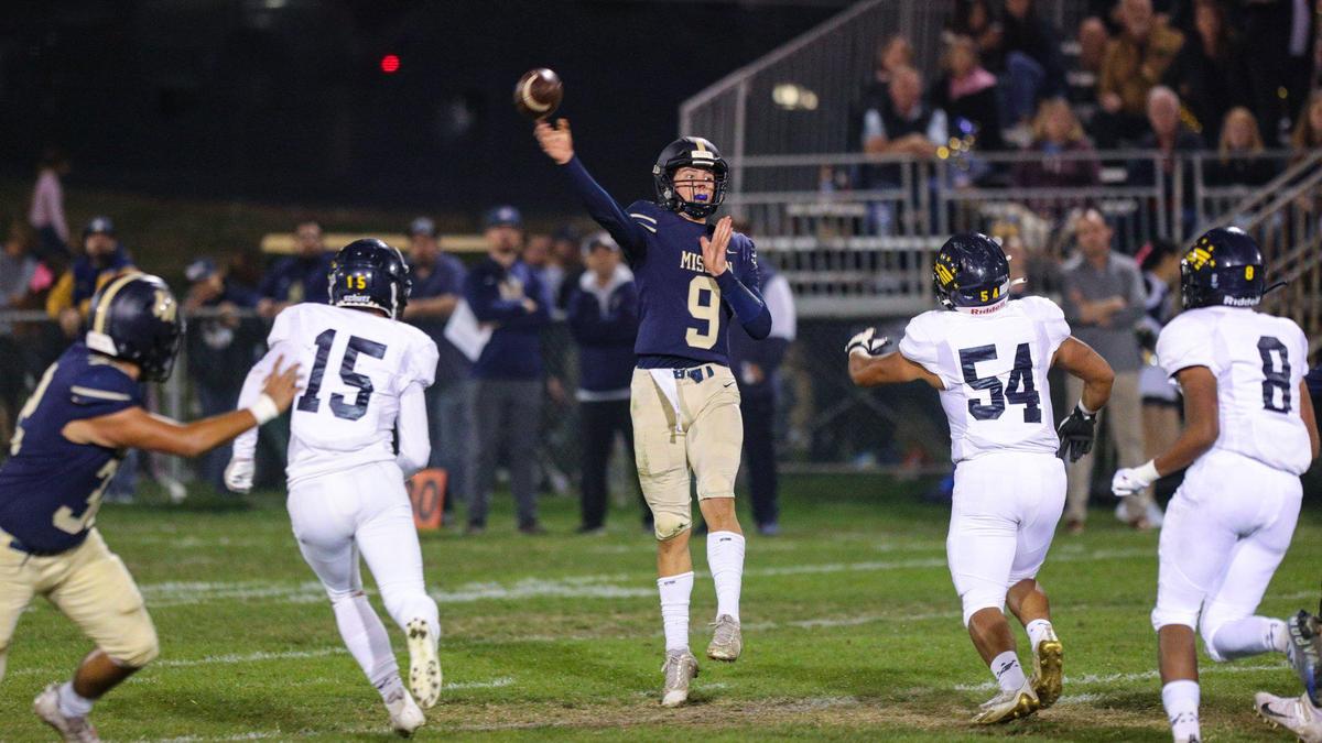 Colby White makes a jump throw over the Arroyo Grande defense. Mission Prep beat Arroyo Grande 41-35 in a Mountain League football game on Oct. 14, 2022.