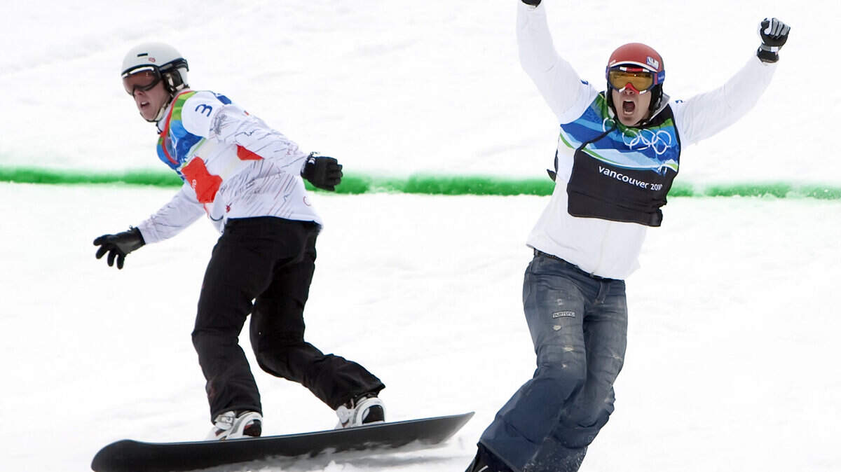 Seth Wescott of the United States celebrates winning gold ahead of Mike Robertson of Canada, left, in the snowboard cross. (George Bridges / MCT)