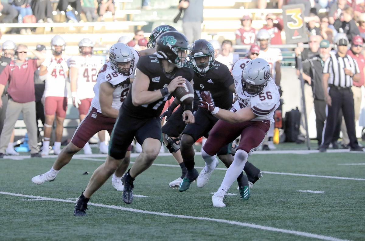 Cal Poly quarterback Richie Watts tries to elude pressure from Montana players. Cal Poly lost to Montana 42-7 in a college football game at Mustang Memorial Stadium on Nov. 2, 2024.