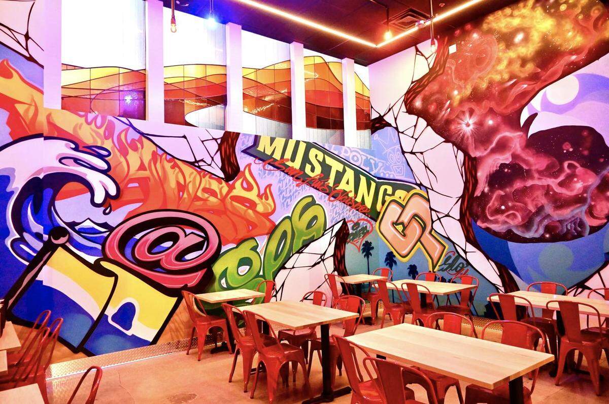 Dave’s Hot Chicken features a colorful dining room decorated with a locally themed mural.