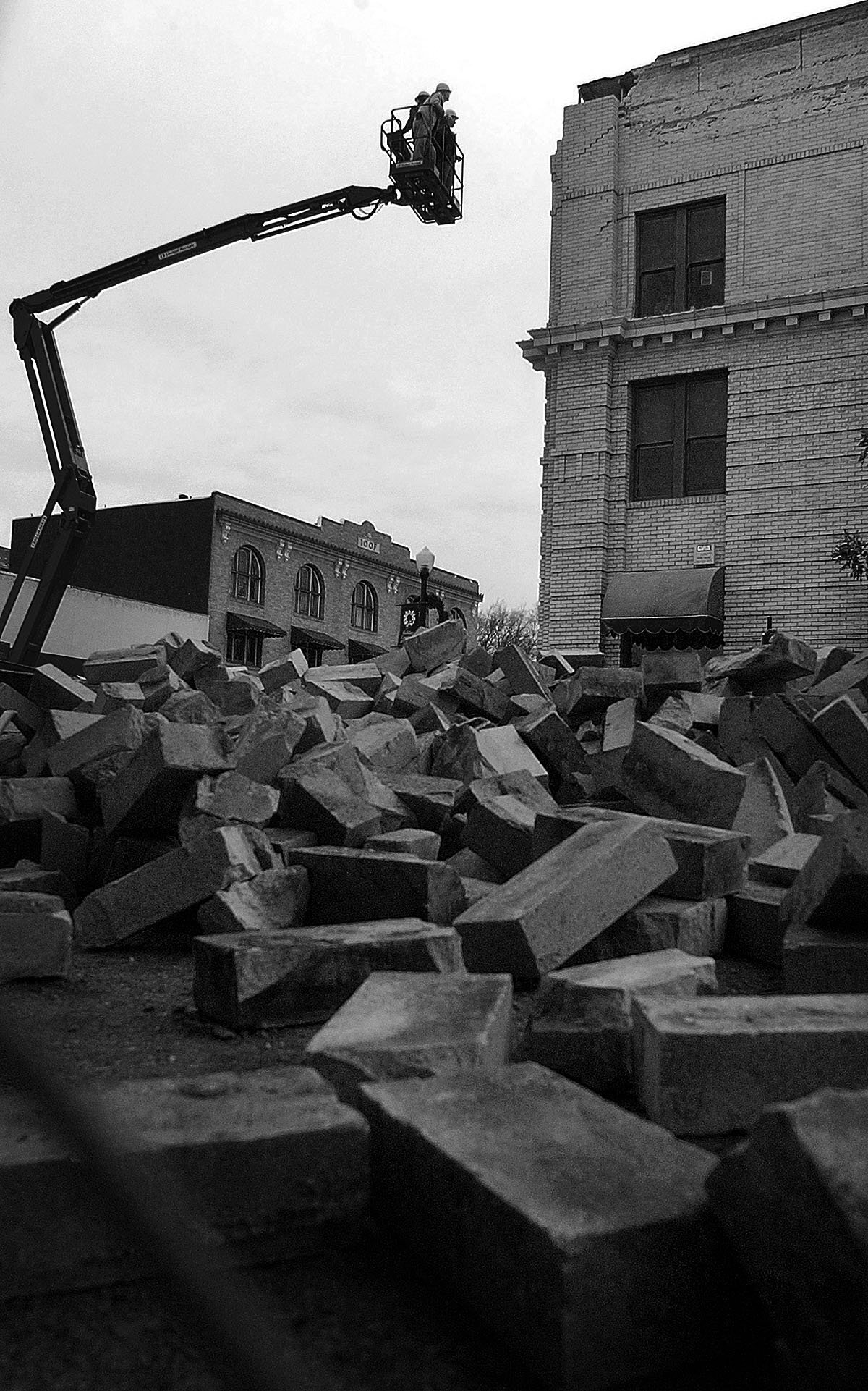 Workers removed some of the hanging bricks from the former Bank of Italy building at the corner of 13th and Park streets in Paso Robles. It was damaged in the San Simeon Earthquake.