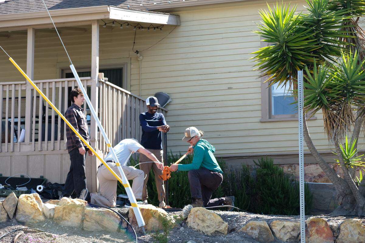 Jacob Negillan, left, Brian Eckenrode, Edward Bentil and Timothy Nelligan test the soil in the front yard of the house next door to Susan Flores’ home in Arroyo Grande on Thursday, May 7, 2026, during the second day of a search warrant investigation in the Kristin Smart murder case.