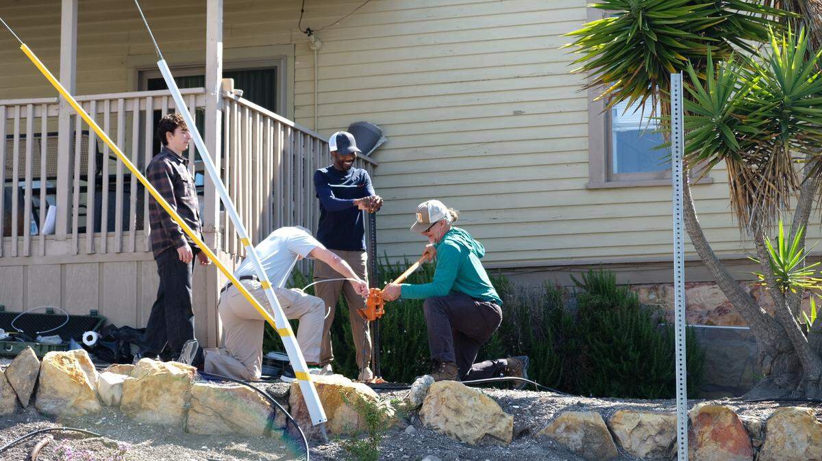 Jacob Nelligan, left, Brian Eckenrode, Edward Bentil and Timothy Nelligan test the soil in the front yard of the house next door to Susan Flores’ home in Arroyo Grande on Thursday, May 7, 2026, during the second day of a search warrant investigation in the Kristin Smart murder case.
