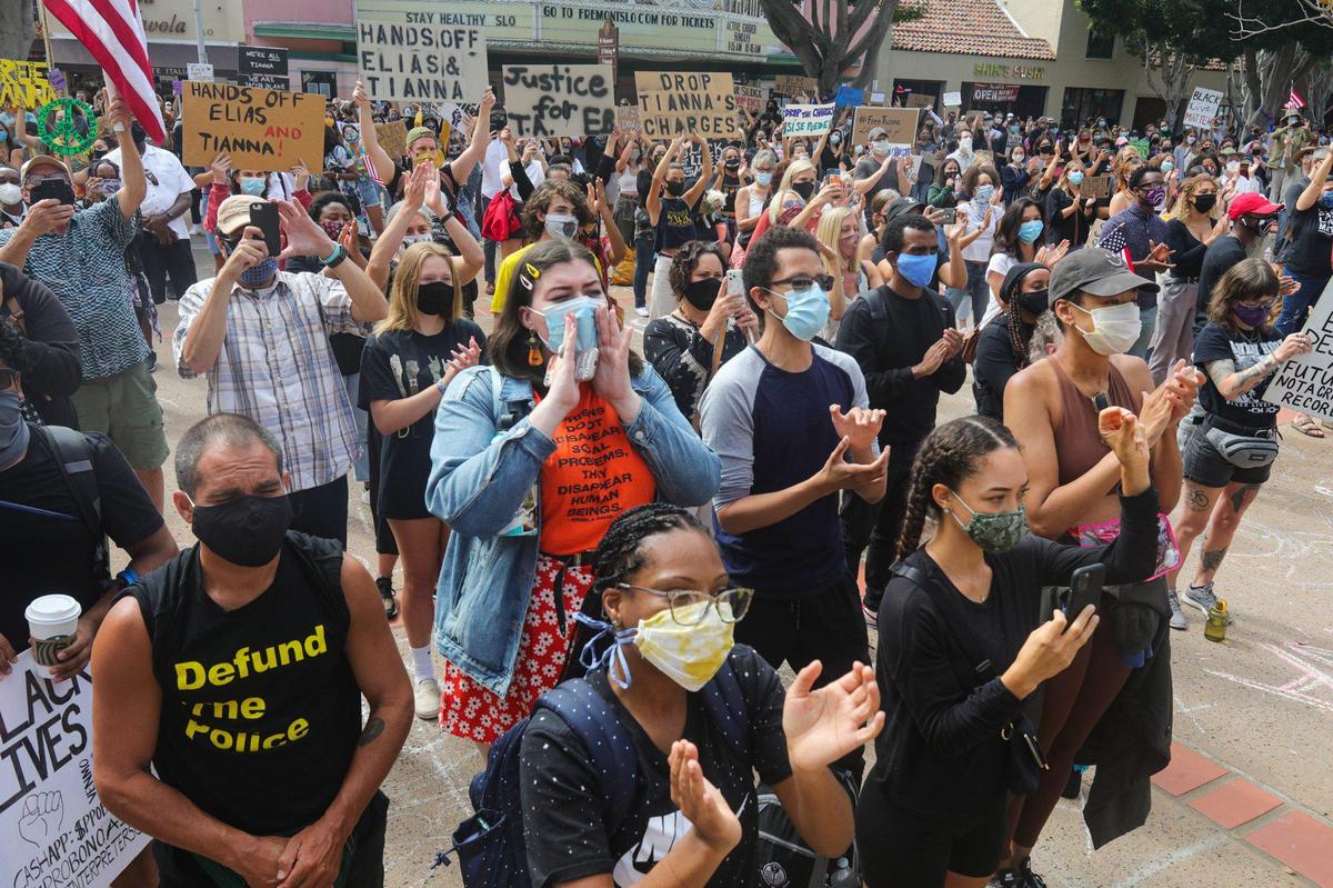 The crowd of applauds as Tianna Arata speaks during a #FreeTianna rally in August 2020 outside the San Luis Obispo County Courthouse. Event organizers called for District Attorney Dan Dow to drop the case against Arata.