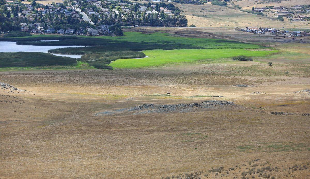 A 360-acre Alberti-Madonna ranch property is listed for sale as ag land, but it suggests it could be rezoned in the future for residential. The property is an L shape at the base of Cerro San Luis to Laguna Lake.