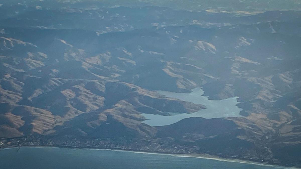 A view of a full Whale Rock Reservoir above Cayucos from an Alaska Airlines flight as it takes off from San Luis Obispo County Regional Airport on the way to Seattle on the morning of July 16, 2024.