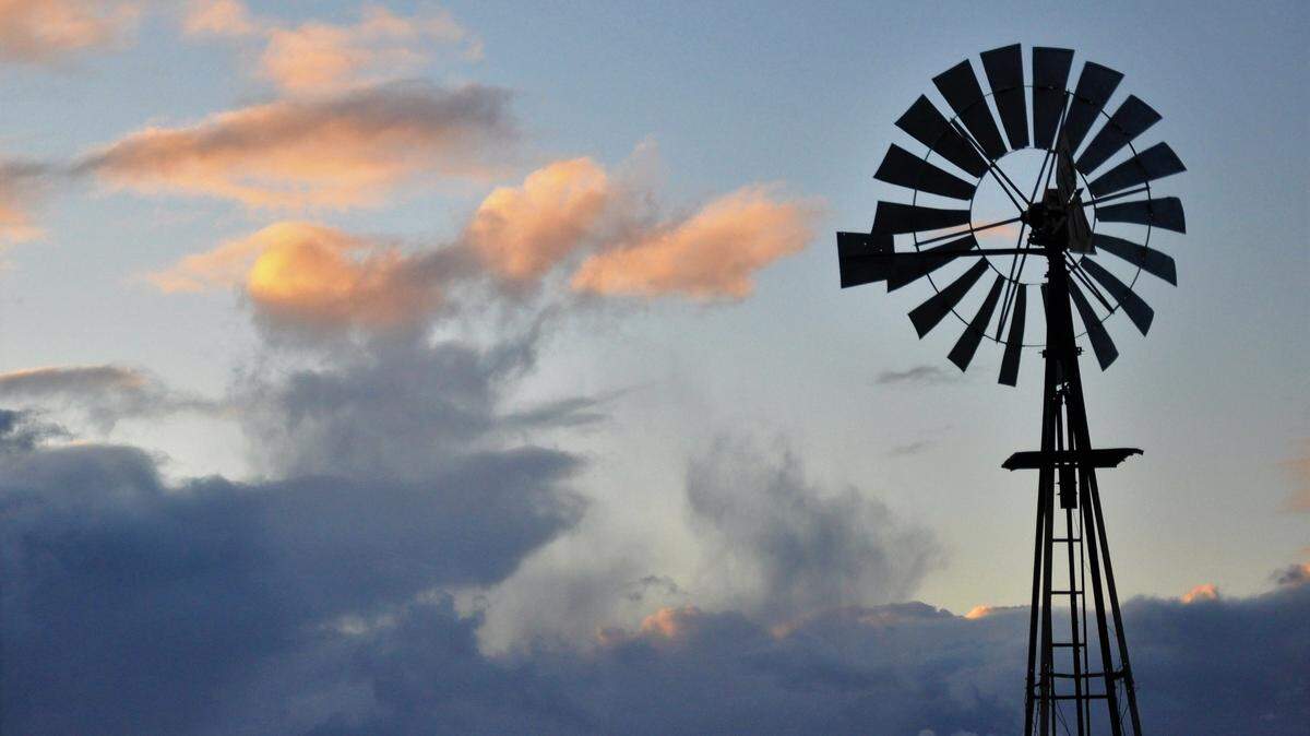A still windmill stands before a cloud bank on Turri Road near Los Osos.
