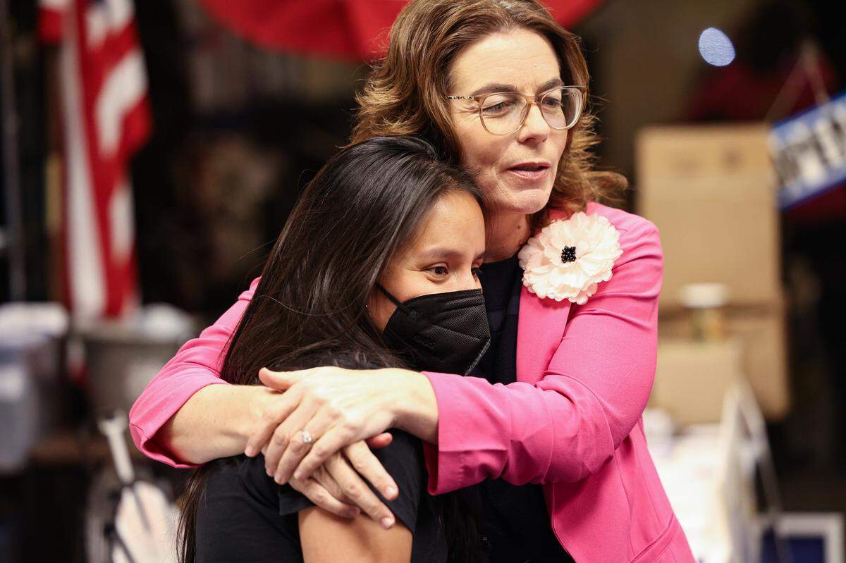San Luis Obispo County Democratic Party Chair Rita Casaverde, left, gets a hug from Dawn Addis on election night, June 7, 2022, as a thank you for her work for candidates. Addis was leading the race for the District 30 state Assembly seat.