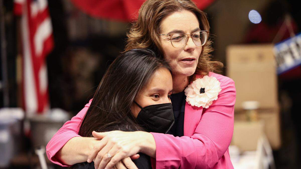 San Luis Obispo County Democratic Party Chair Rita Casaverde, left, gets a hug from Dawn Addis on election night, June 7, 2022, as a thank you for her work for candidates. Addis was leading the race for the District 30 state Assembly seat.