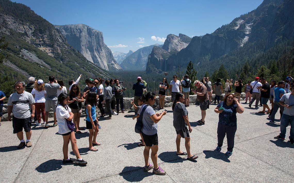 Visitors crowd Tunnel View overlooking Yosemite Valley in Yosemite National Park.