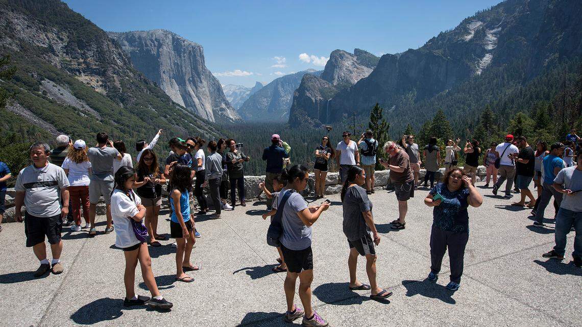 Visitors crowd Tunnel View overlooking Yosemite Valley in Yosemite National Park.