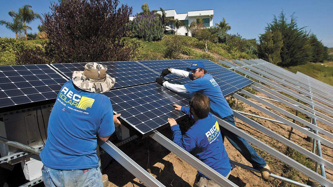 REC Solar employees install solar panels at a home in Arroyo Grande in 2010.