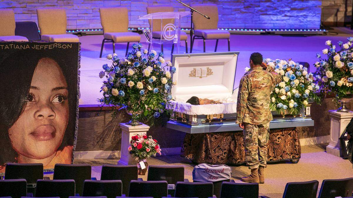 A soldier salutes Atatiana Jefferson before her funeral at Concord Church in Dallas on Thursday.