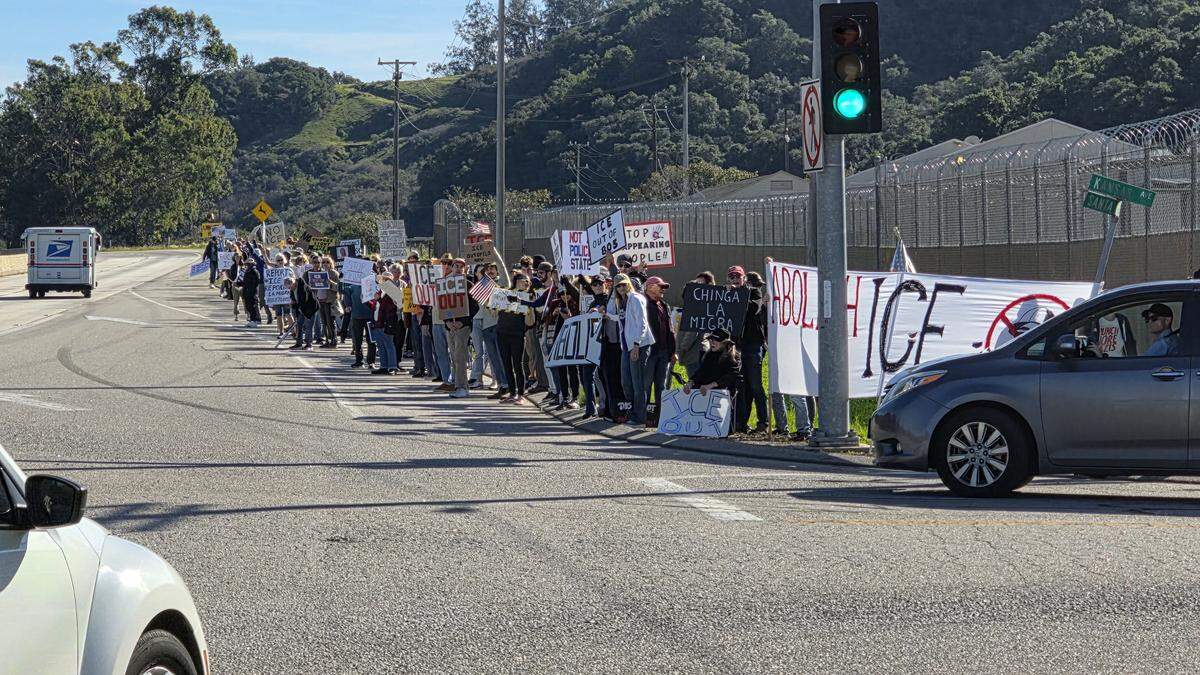 More than 250 people gathered at Highway 1 and Kansas Avenue to protest ICE in San Luis Obispo on Jan. 11, 2026.
