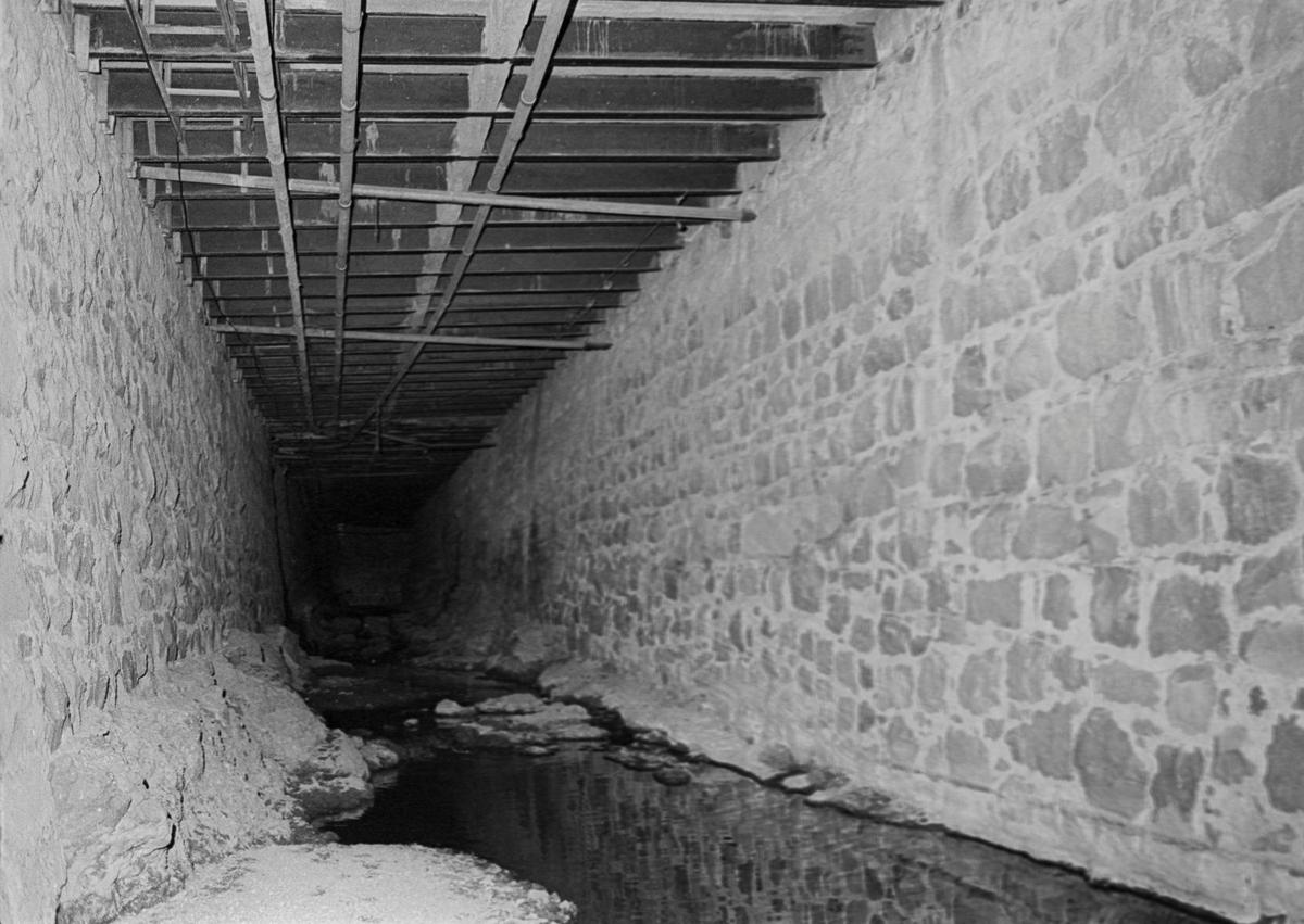 Rock walls were likely quarried from Bishop Peak stone, it reminded the article writer of a medieval dungeon. San Luis Creek flows under the city for a little over two blocks below Higuera Street. Most of the route is unlit darkness. This view is from Sept. 5, 1975.