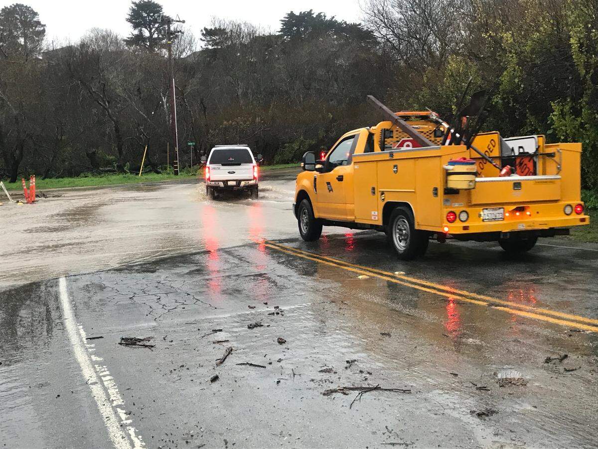 A Cambria Fire Department vehicle and county truck gingerly traverse remaining floodwaters on Windsor Boulevard in Cambria after officials reopened the access road to Park Hill on Jan. 9, 2023. Earlier that day, deeper runoff and public-safety concerns  had prompted a seven-hour closure of the busy road. If the floodwaters rise again during incoming storms, officials may need to close the boulevard down again.