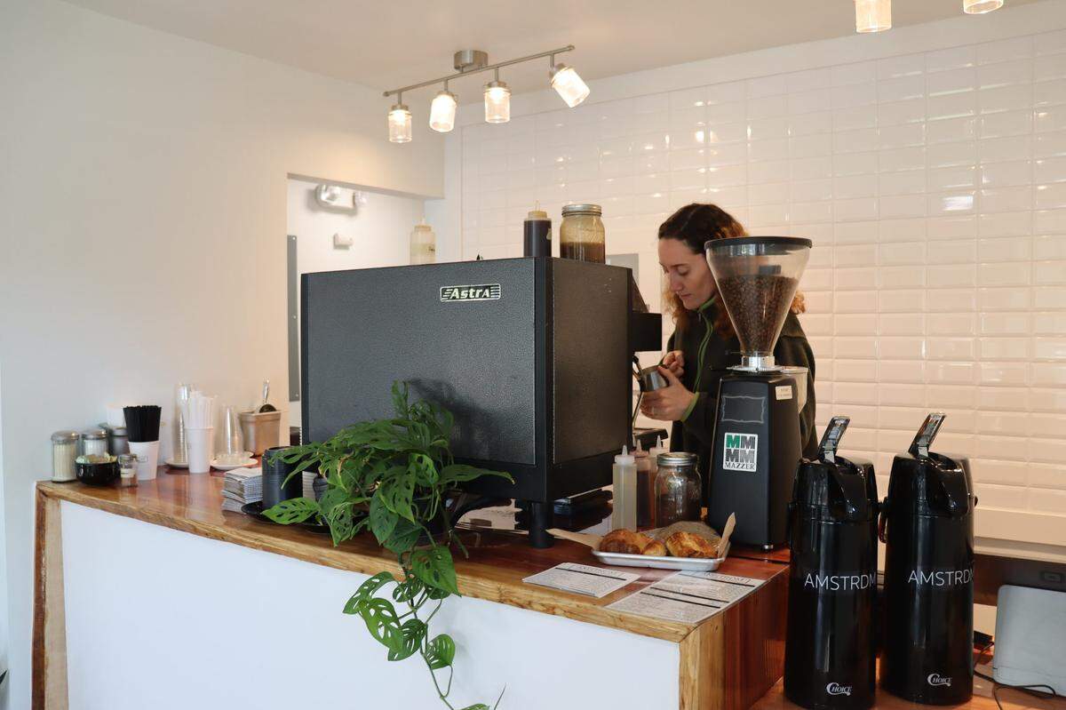 A barista makes a house-made Himalayan Salted Caramel Latte behind the bar at AMSTRDM’s new location in Atascadero.