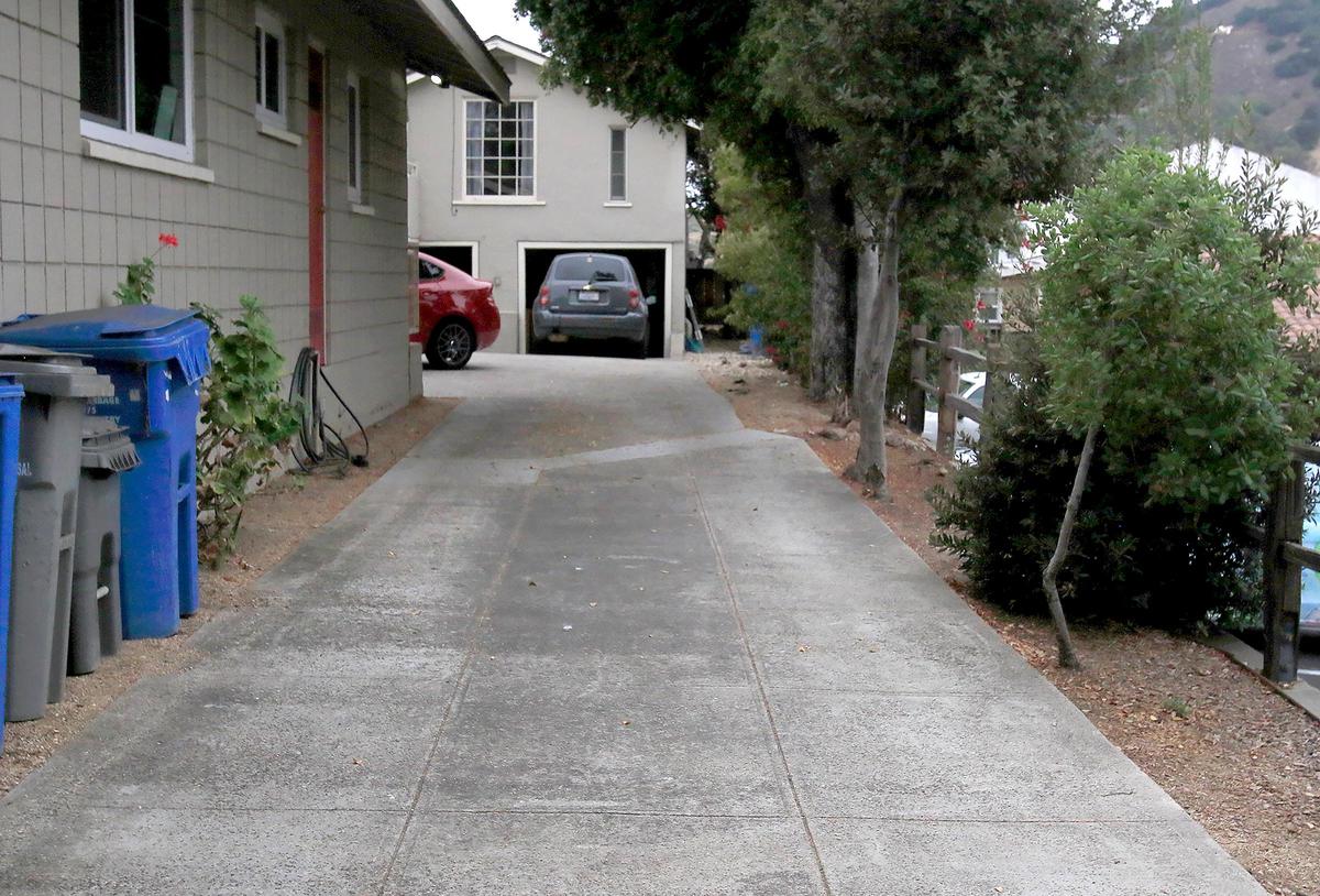 Three white ricochet marks from bullets fired by a San Luis Obispo police officer are visible in the driveway of the home of Riley Manford, 27, and Nick Regalia, 33, on the 600 block of Santa Rosa Street. Police shot and killed the couple’s dog after responding to a burglary call at the address.