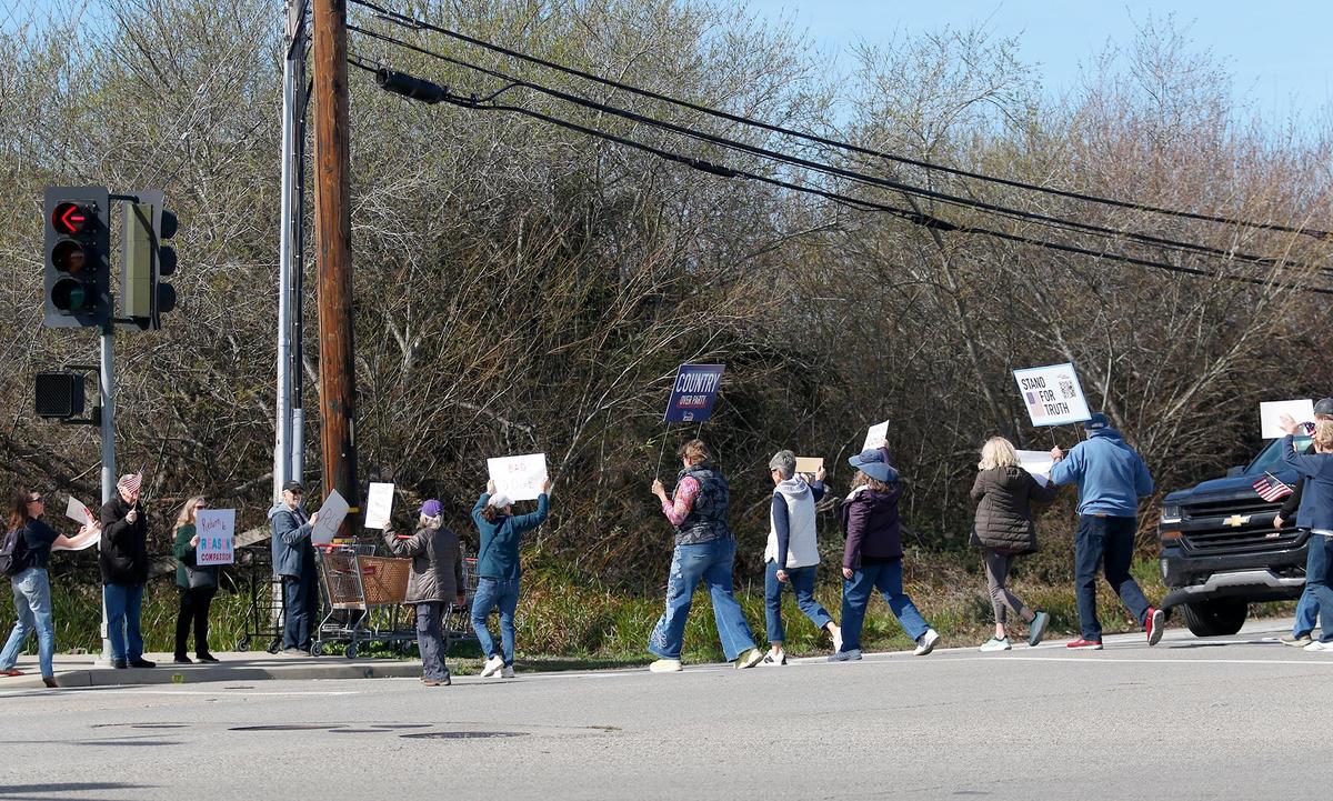 Dozens of people demonstrated outside the Tesla dealership in San Luis Obispo on Saturday, Feb. 8, 2025. They eventually walked from Calle Joaquin to Los Osos Valley Road.