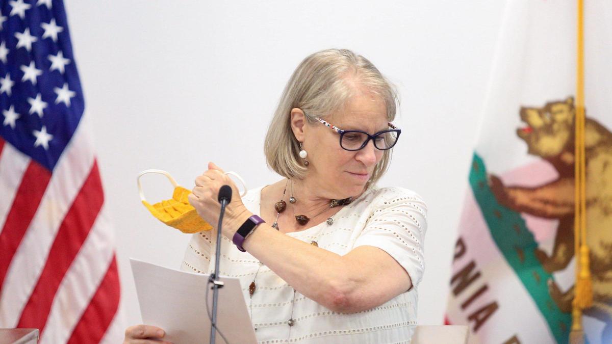 Dr. Penny Borenstein, San Luis Obispo County public health officer, removes her face mask before speaking at a weekly briefing on July 15, 2020, about the latest coronavirus information.