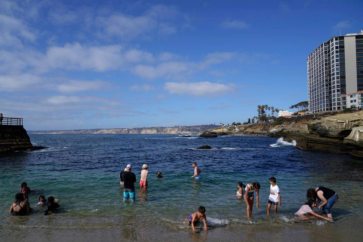 Visitors line an iconic beach at La Jolla Cove on Friday, June 17, 2022, in San Diego. La Jolla Cove is one of the Top 25 Beaches in the United States, according to Tripadvisor.