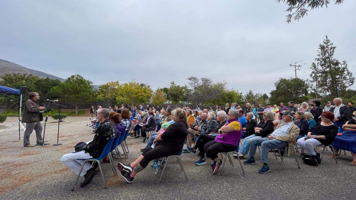 Community Action Partnership of San Luis Obispo homeless services director Jack Lahey speaks to a crowd of around 200 neighbors Wednesday evening in the SLO Naz Church parking lot. The church hosted an informational meeting on a proposed safe parking site that would host homeless residents living in their vehicles at night for one or two months each year as part of the city’s Rotating Overnight Safe Parking program.