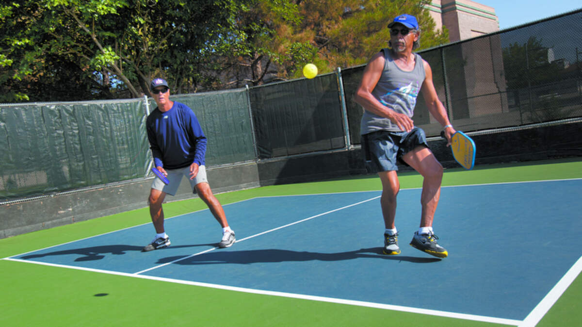 The Paso Robles Pickleball Club hosted a dedication ceremony for the new pickleball courts at Centennial Park which exist as SLO County's first permanent courts for the tennis-like sport. Jack Hodges, Central Coast ambassador for the USA Pickleball Association, and Pete Gomez of Paso Robles, right, play a pickleball game Saturday.