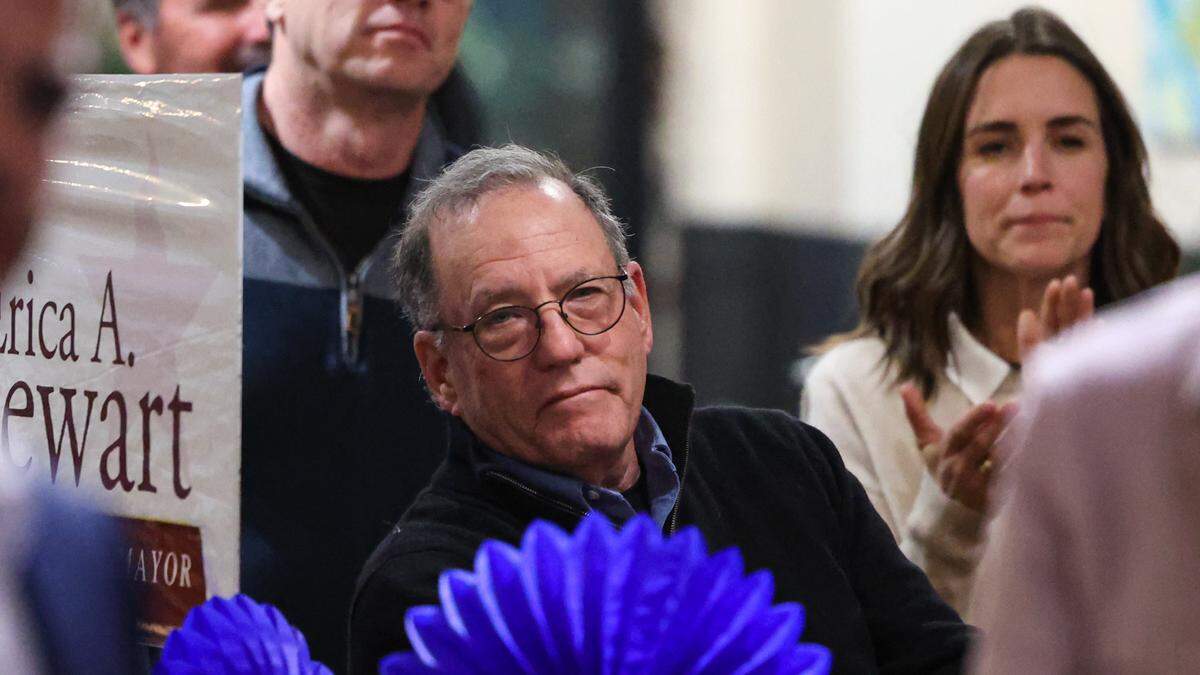San Luis Coastal Unified School District board candidate Mark Buchman, center, listens during an election night event on Tuesday, Nov. 8, 2022.