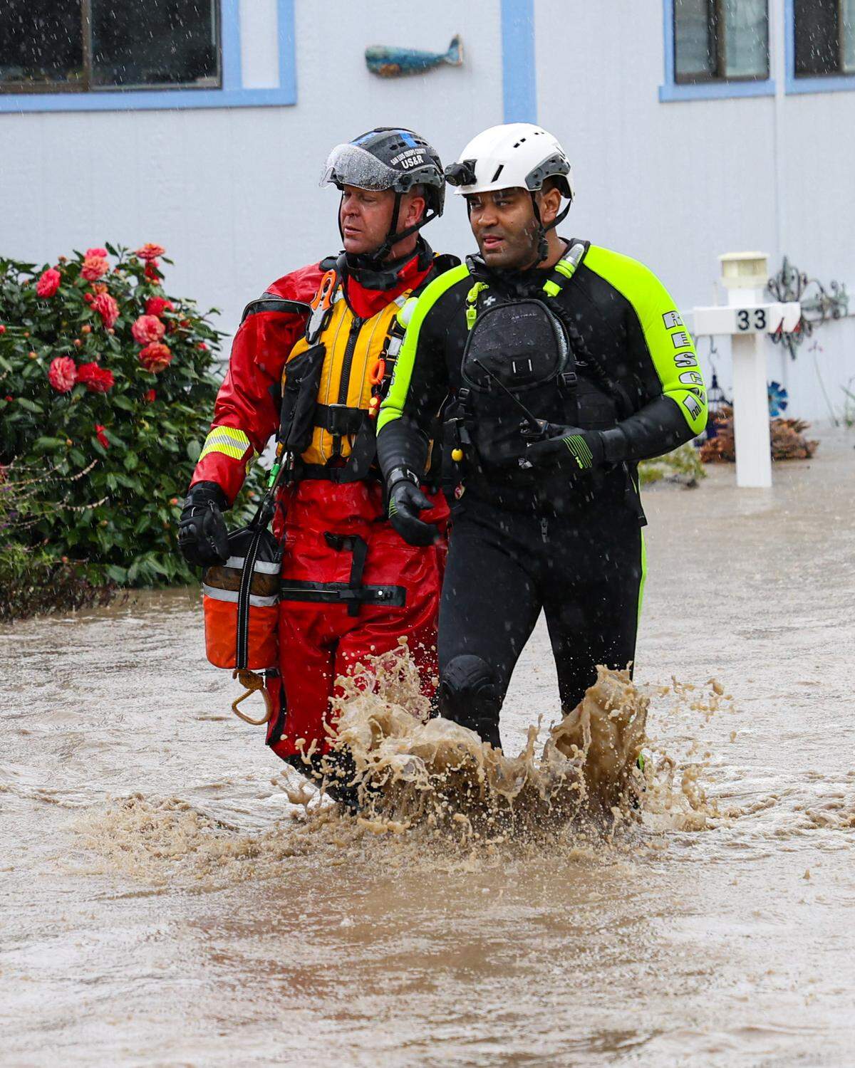 Capt. Michael Burkey with Cambria Fire, at left, and Chief Justin Vincent go door-to-door evacuating residents as Santa Rosa Creek flooded Oak Terrace Mobile Home Park triggering evacuations on March 10, 2023.
