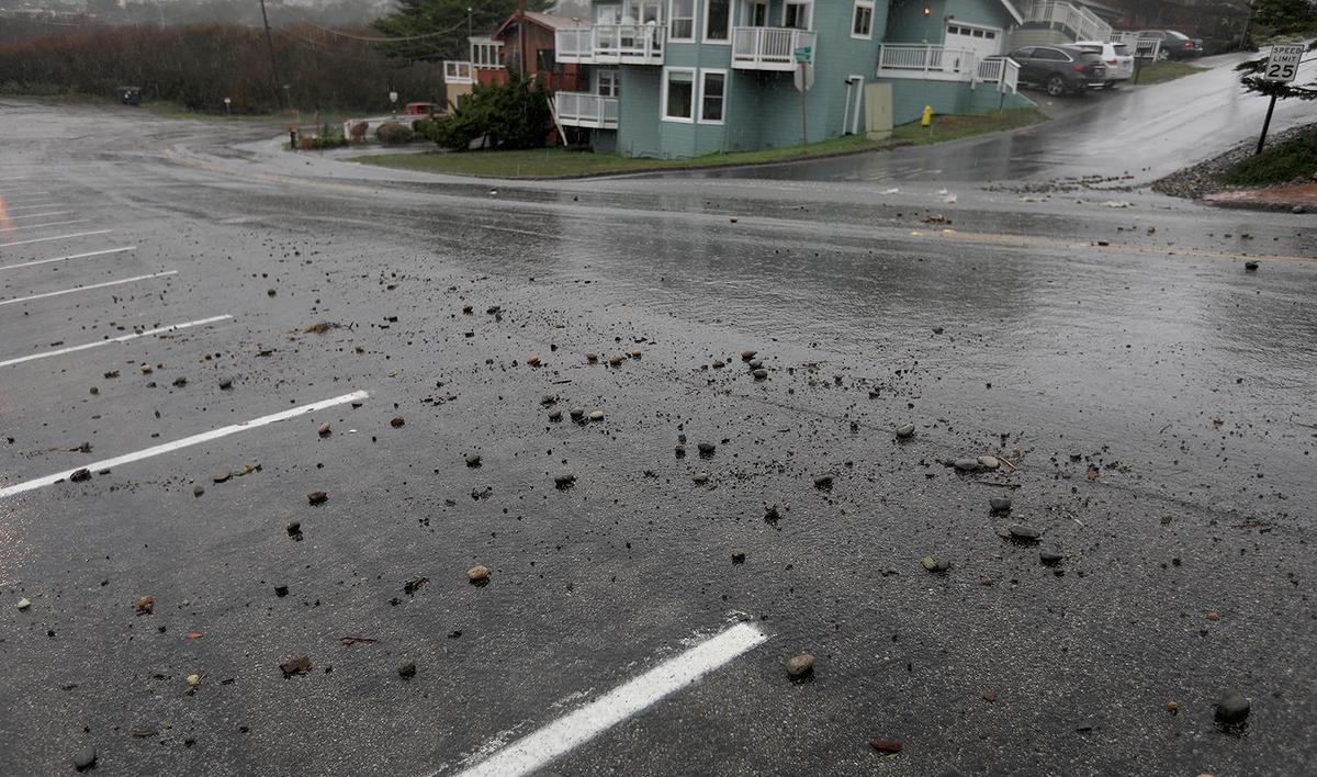 Rocks and water pour down Windsor Boulevard in front of Shamel Park in Cambria. A strong storm hit the North Coast area with heavy rain and high winds on Wednesday, Jan. 27, 2021.