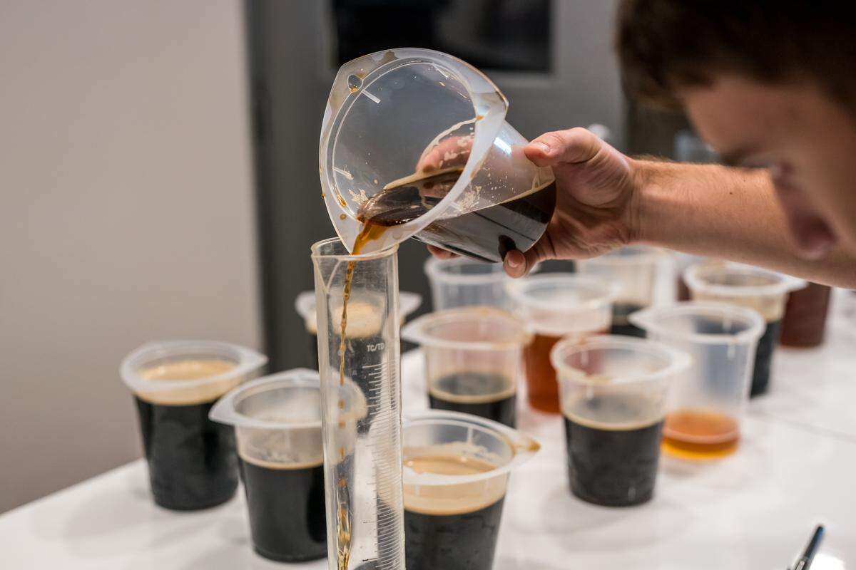 A participant in an Anniversary Ale blending competition at Firestone Walker Brewing Co. in Paso Robles carefully measures beer.
