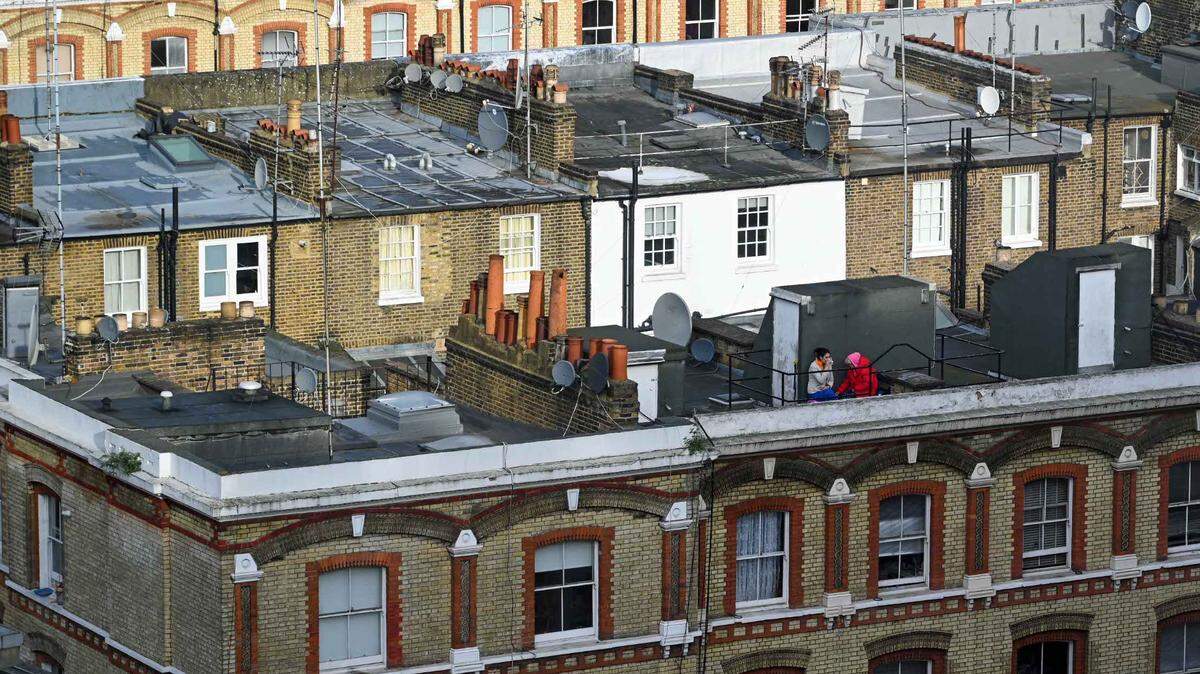 Two ladies enjoying tea or coffee on top of one of the thousands and thousands of roofs of London.