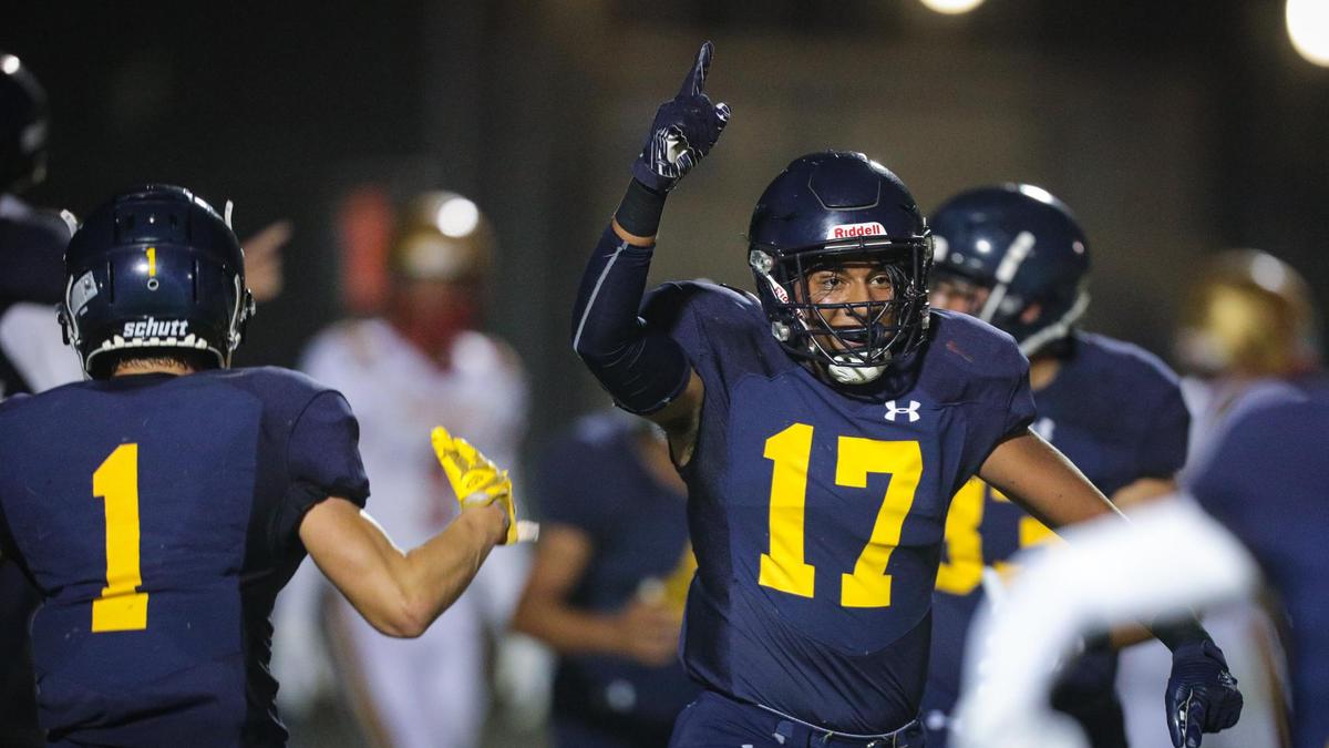 Brody Bottini and the defense celebrate a fumble recovery that stalled a scoring drive by Centennial of Bakersfield. Arroyo Grande lost 39-7 on Aug. 26, 2022.