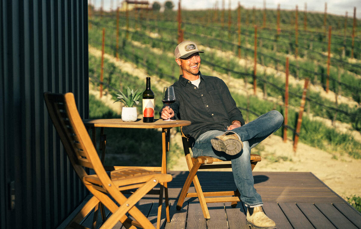 Kyle Jury sits outside his vineyard in Paso Robles. The Truss Wines estate grows Rhone variety grapes, but also makes chardonnay and pinot noir.