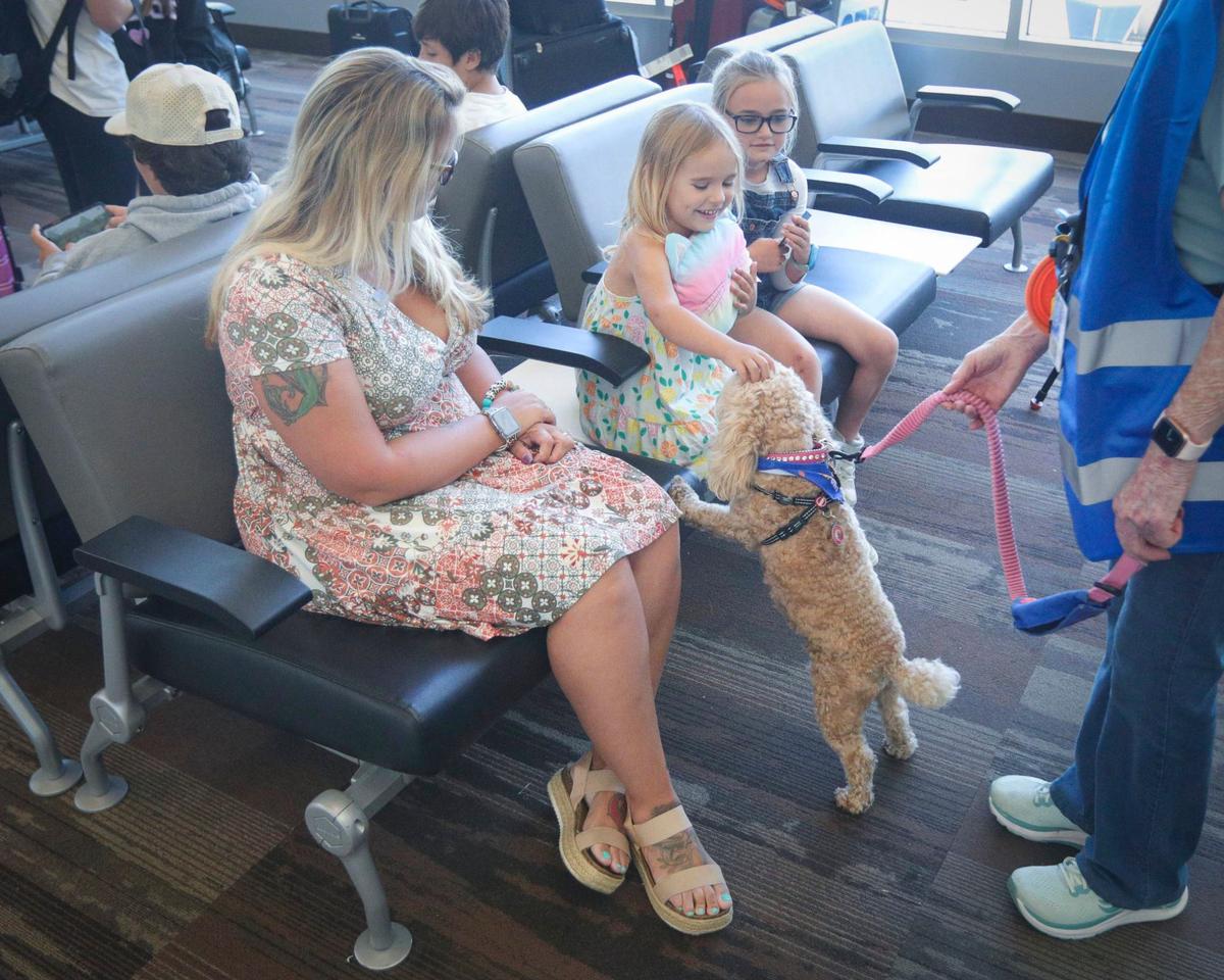 From the left: Jourdan Bruhns, daughter Addison, 4, and Evelyn, 8, get introduced to Bella by Barbara Nicholson.