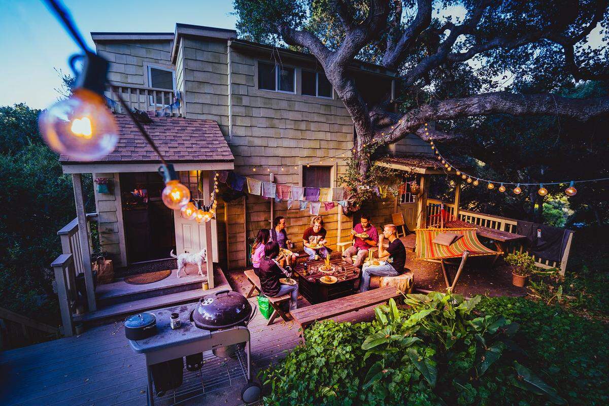 Friends gather for dinner in July 2017 at the tree house apartment at 765 Price Canyon Road.