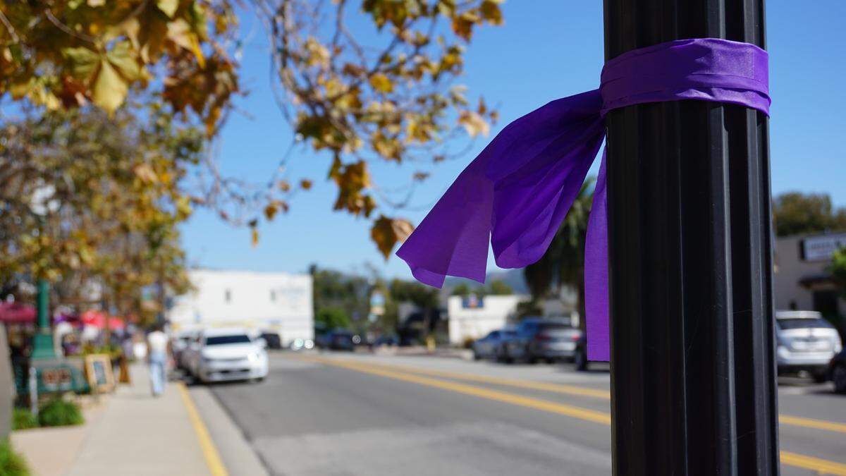 Purple ribbons are attached to posts and signs in the Arroyo Grande Village in honor of Kristin Smart and ahead of the verdicts in the Paul Flores murder trial.