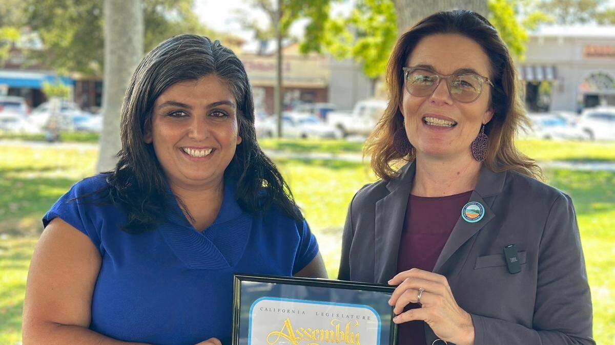 California State Assemblymember Dawn Addis, right, presents legal advocate Khouloud Pearson, left, with the award for 2024 Woman of the Year for the 30th Assembly District.