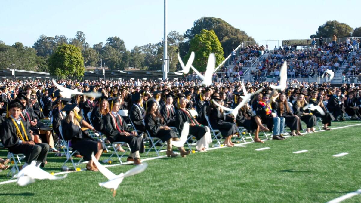 White homing pigeons take to the air at San Luis Obispo High School's commencement ceremonies at Holt Field on Friday, June 5, 2026. 374 seniors received their diplomas.