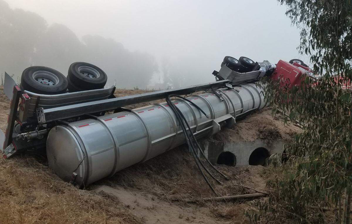 A tanker truck carrying oil rests on its side after rolling off Willow Road in Nipomo in September 2018.