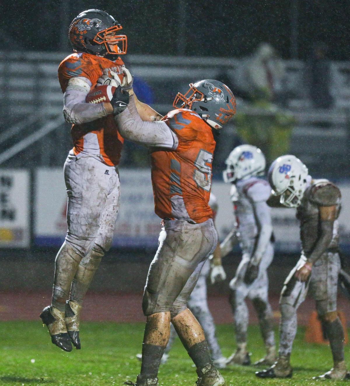Trey Cooks is held up by Anthony Tejada after Cooks scored one of his four touchdowns. The Atascadero Greyhounds beat the San Gabriel Matadors 41-0 to win the CIF Division 6-A State Championship football game on Dec. 10, 2022.