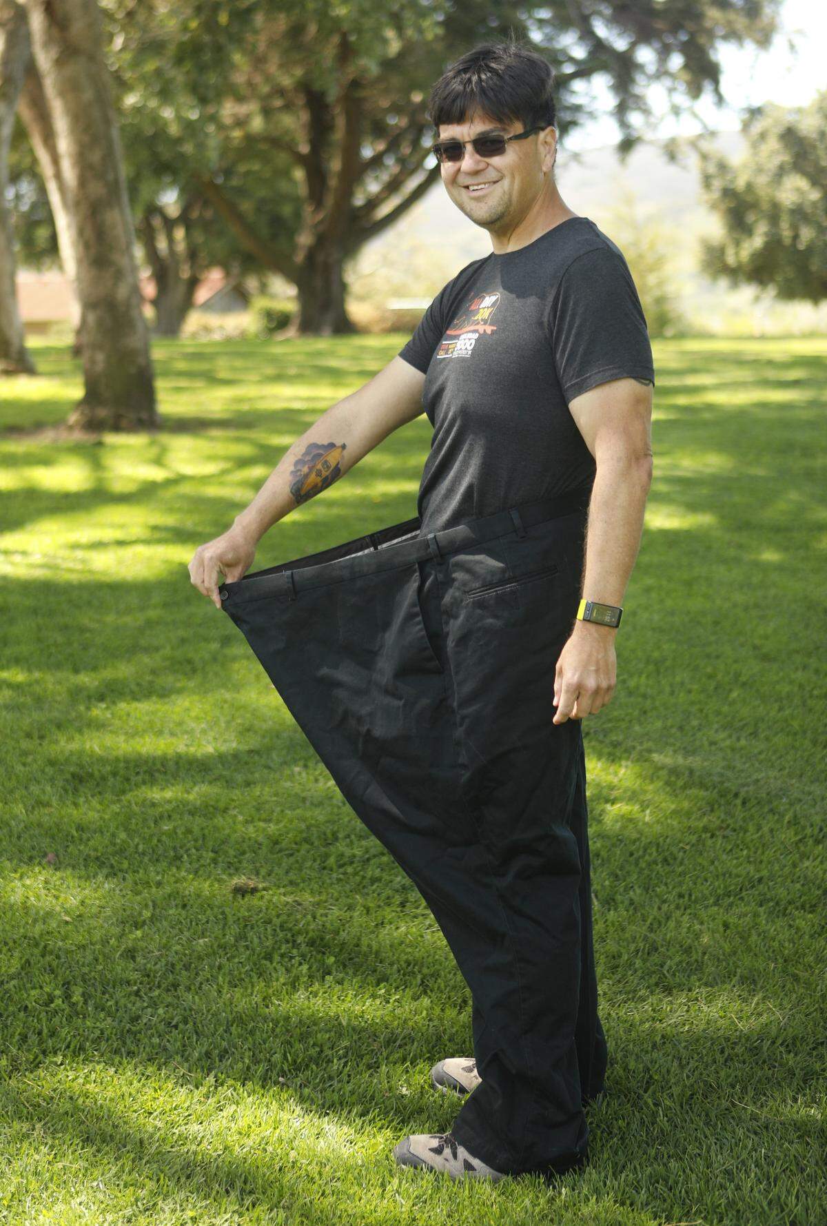 San Luis Obispo bus driver James Lacher weighed 400 pounds in 2015, but after having bariatric surgery and changing his diet, he lost half his body weight and is ready to run in the San Luis Obispo Marathon on Sunday, April 29, 2018. He stands inside his old size 60 pants from three years ago.