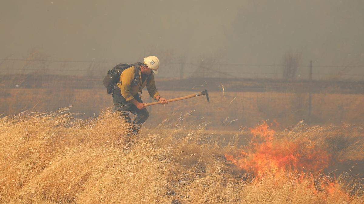 Firefighters respond to the Garrison Fire burning in the southern part of Monterey County on Sunday, July 3, 2022.