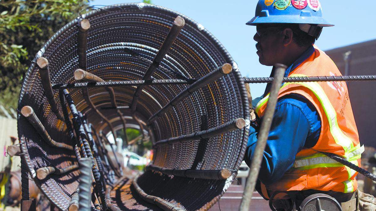 Jose Precdo wires reinforcing bar into caisson shape that will be lowered into the ground to and have concrete around. He is working at the new San Luis Obispo County women's jail under construction.