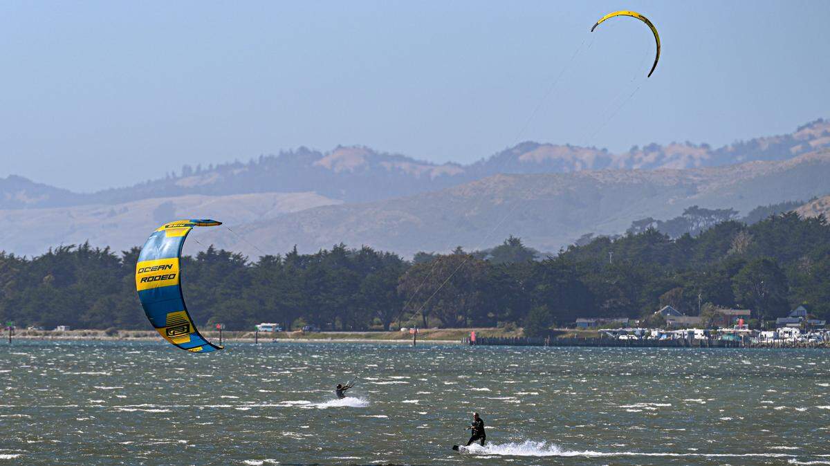 Kitesurfers during gale-force northwesterly winds on Bodega Bay.