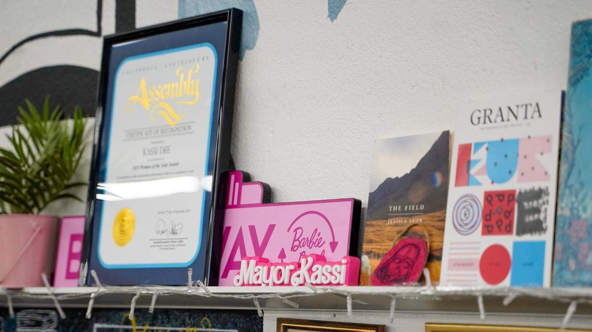 Decorations including a proclamation from California State Representative Dawn Addis and a Barbie-themed nameplate for new Grover Beach Mayor Kassi Dee sit on a shelf at Nan’s Books and Crystals on Thursday, Jan. 9, 2025. Dee was elected in 2024 as the youngest mayor in the history of Grover Beach.