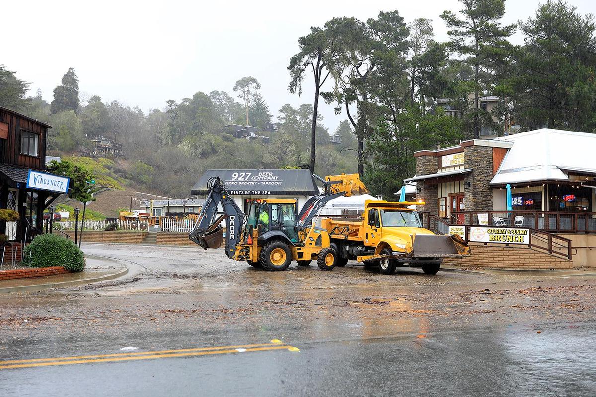 County workers use heavy equipment to clean up mud and debris on Sheffield Lane and Main Street in Cambria. A strong storm hit the North Coast area with heavy rain and high winds on Wednesday, Jan. 27, 2021.
