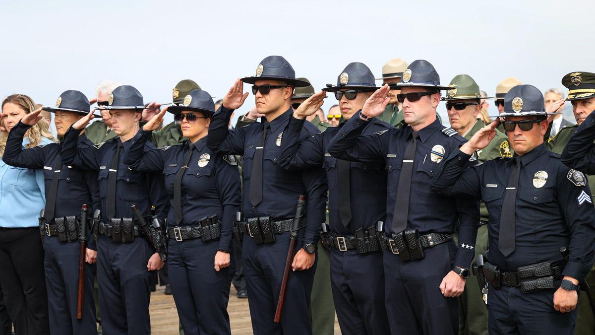 Members of the San Luis Obispo Police Department salute during the 2022 Peace Officers’ Memorial on Thursday, May 5, 2022, at the Pismo Beach Pier. One of their fellow officers, Det. Luca Benedetti, died in the line of duty almost one year prior.