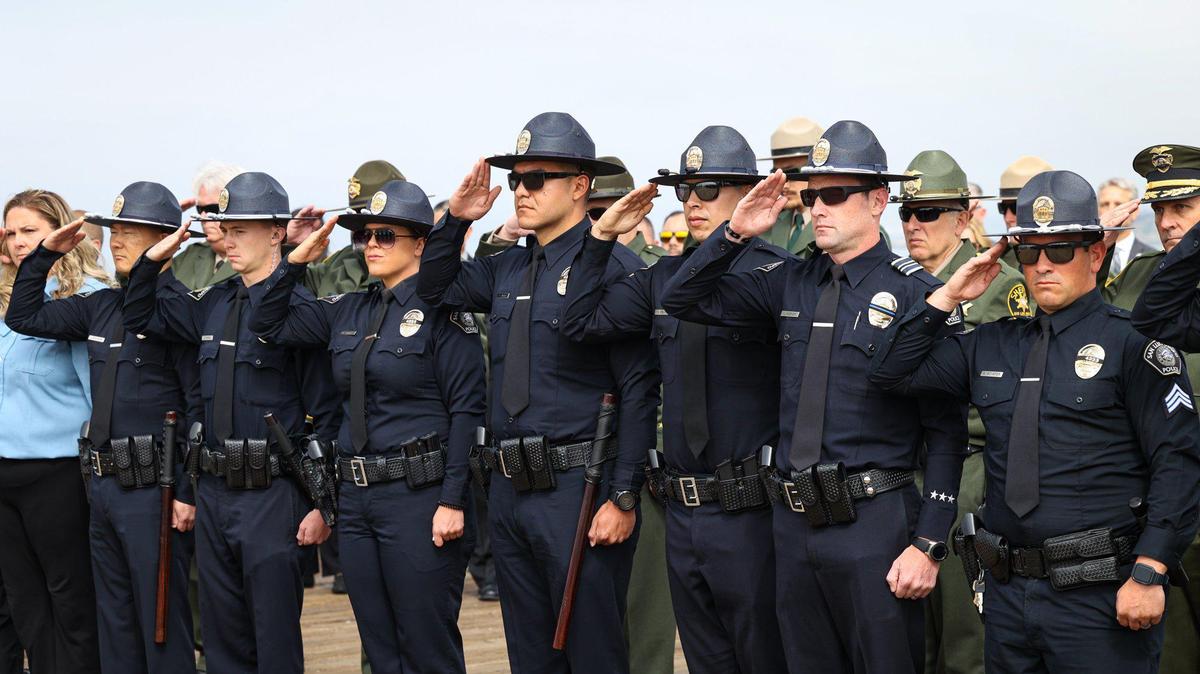 Members of the San Luis Obispo Police Department salute during the 2022 Peace Officers’ Memorial on Thursday, May 5, 2022, at the Pismo Beach Pier. One of their fellow officers, Det. Luca Benedetti, died in the line of duty almost one year prior.