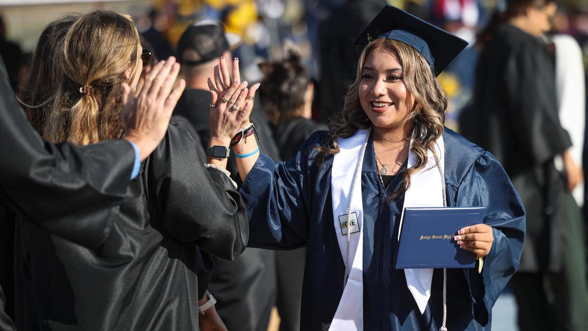 Maria Rodriguez Delgado gets high fives from faculty after picking up a diploma. Arroyo Grande High School held commencement for 520 graduates on June 5, 2025.